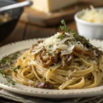 Savory French Onion Pasta on a plate with melted cheese and caramelized onions